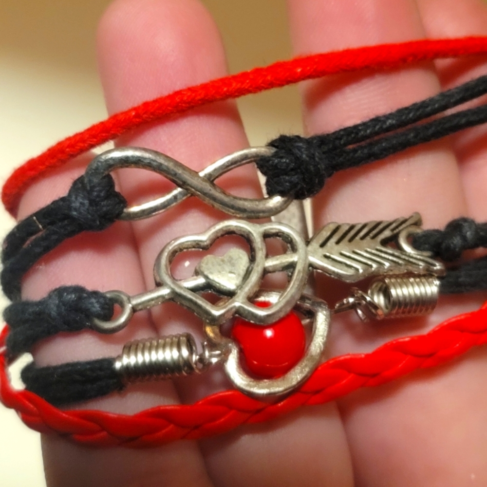Layered red and black rope bracelet w/ silver charms